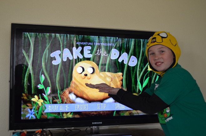 Modeling his new Jake Hat while showing off the Jake the Dad DVD. Photo: Patricia Vollmer.