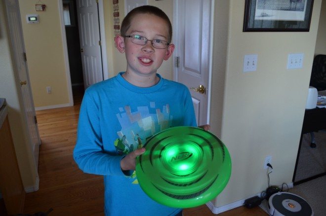 My youngest son shows off the Nerf FireVision Ignite flying disc in its well-lit glory. Photo: Patricia Vollmer.