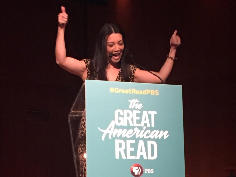 a photo of Ming-Na Wen at the Great American Read announcement giving two thumbs up