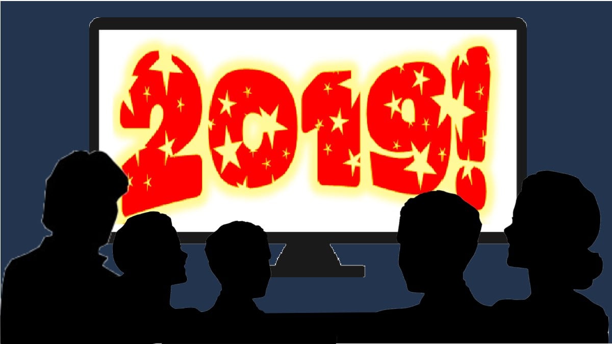 a family of silhouettes sitting in front of a large screen tv that says "2019!"