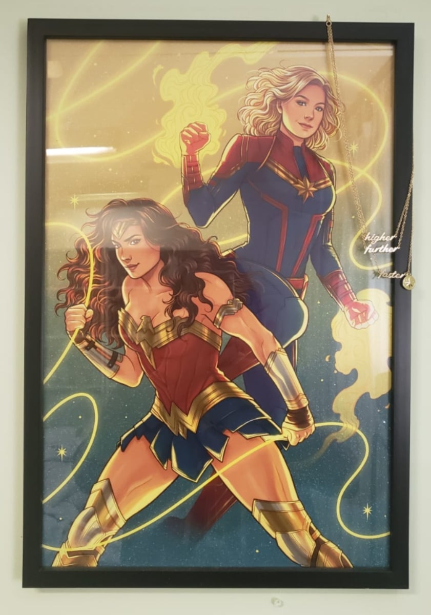 A framed image of Wonder Woman and Captain Marvel side by side. Art by Jen Bartel.