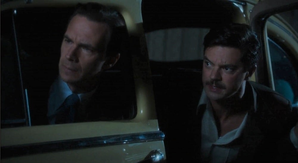 Edwin Jarvis and Howard Stark, circa 1946, leaning out of a car to look in shock at something 