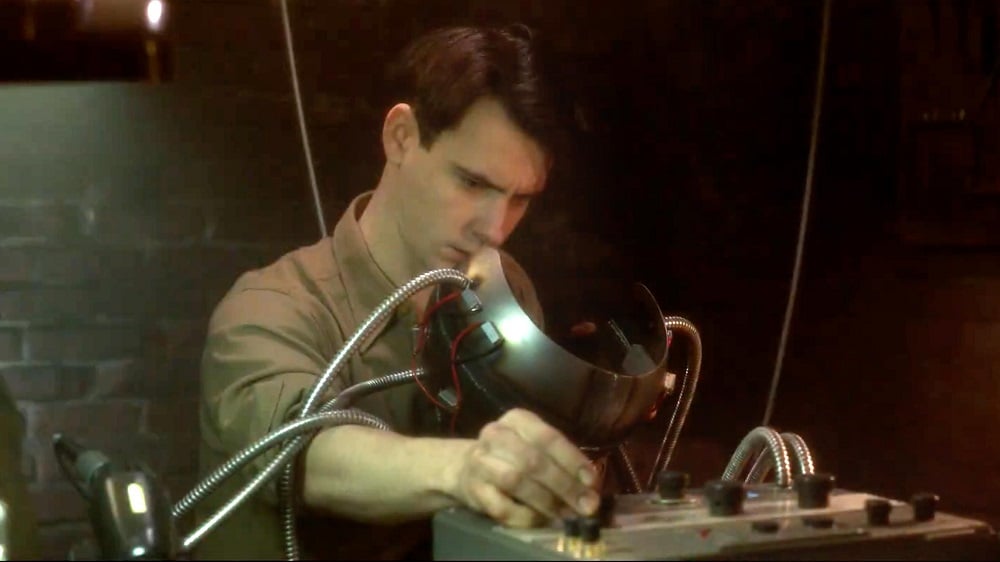 Harry Lloyd as Charles Xavier working on a Cerebro prototype