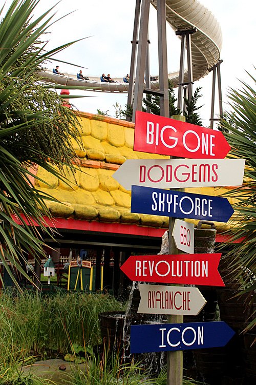 A Signpost at Blackpool Pleasure Beach with Avalanche Behind, Image: Sophie Brown